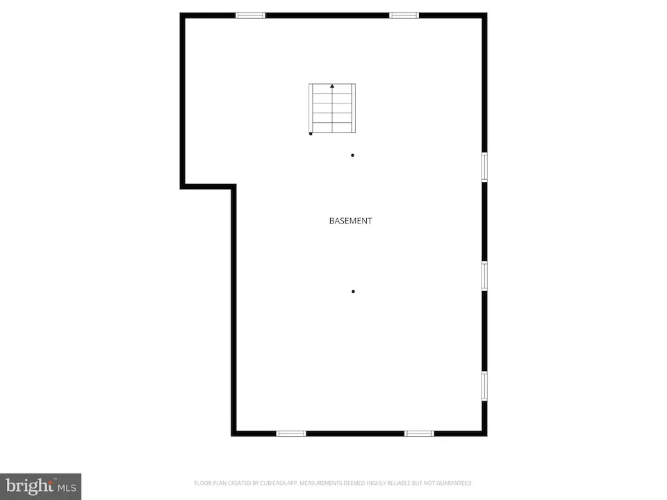 Basement floor plan: large rectangular room with a stairwell near the top center, an indentation on the left wall, and doors along the right wall.