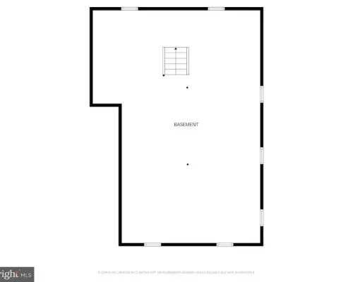 Basement floor plan: large rectangular room with a stairwell near the top center, an indentation on the left wall, and doors along the right wall.